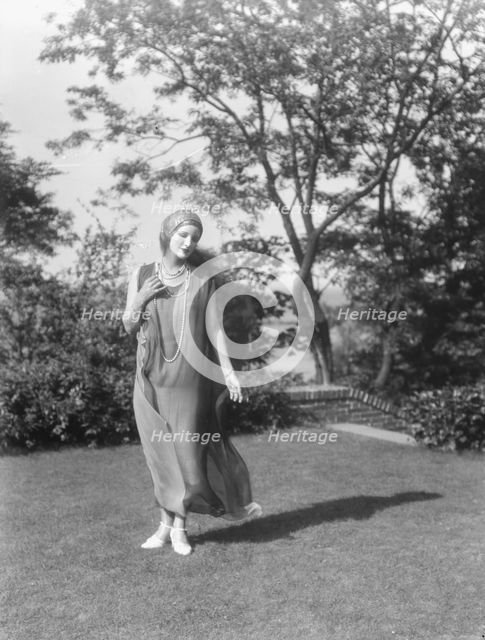 Person wearing a mask made by W.T. Benda, 1925 Sept. 20. Creator: Arnold Genthe.