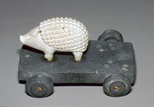 Persian hedgehog mounted on a wheeled carriage