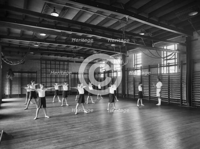 Physical Education in the gymnasium, Merchant Taylors School, Northwood, Hertfordshire, 1933-1939 Artist: Marshall Keene and Company.