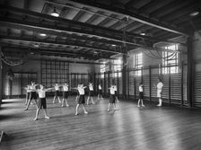 Physical Education in the gymnasium, Merchant Taylors School, Northwood, Hertfordshire, 1933-1939 Artist: Marshall Keene and Company
