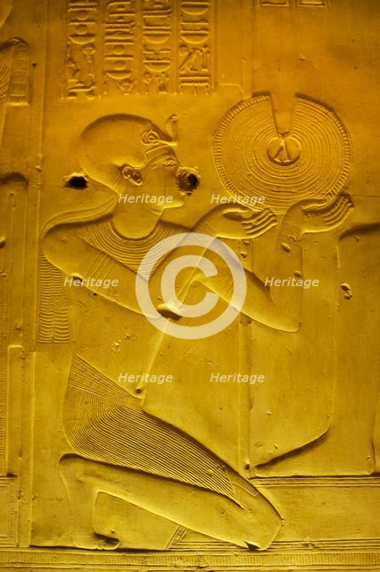 Pharaoh making an offering of a gold necklace, Temple of Seti I, Abydos, Egypt, New Kingdom (2003). Creator: LTL.
