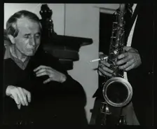 Phil Bates and the tenor saxophone of Spike Robinson at The Bell, Codicote, Hertfordshire, 1986. Creator: Denis Williams