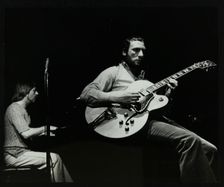 Phil Lee (guitar) and Michael Garrick (piano) playing at The Stables, Wavendon, Buckinghamshire. Creator: Denis Williams