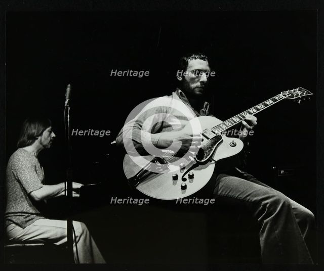 Phil Lee (guitar) and Michael Garrick (piano) playing at The Stables, Wavendon, Buckinghamshire. Creator: Denis Williams.