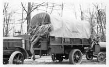 Photo of three soldiers sitting on a truck, Fort Sheridan, Illinois, USA, 1933