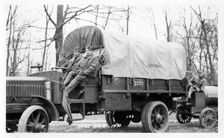 Photo of three soldiers sitting on a truck, Fort Sheridan, Illinois, USA, 1933