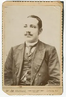 Photograph of a man wearing a dark colored suit with a pocket watch in his vest, 1886-1900. Creator: W. M. Hubbard
