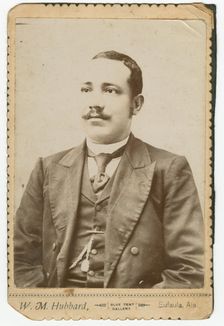 Photograph of a man wearing a dark colored suit with a pocket watch in his vest, 1886-1900. Creator: W. M. Hubbard