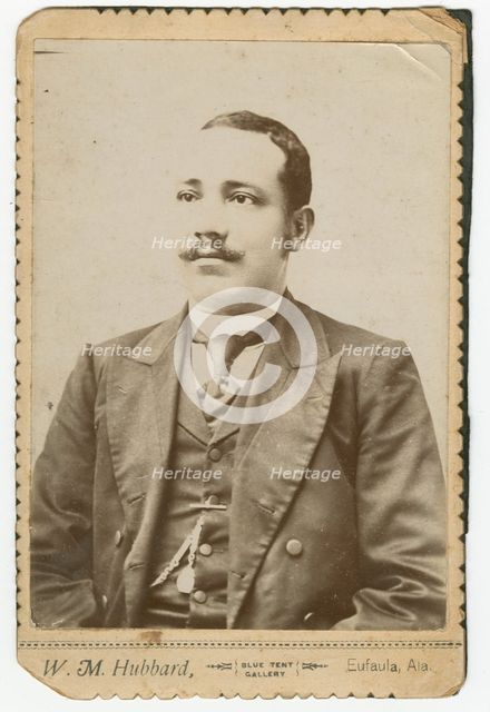 Photograph of a man wearing a dark colored suit with a pocket watch in his vest, 1886-1900. Creator: W. M. Hubbard.