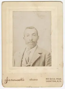 Photograph of a man wearing a light colored jacket, vest and necktie, late 19th century. Creator: Louis Janousek