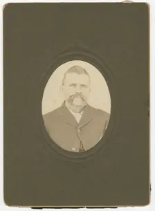 Photograph of a man with a mustache wearing a dark jacket, late 19th century. Creator: Unknown
