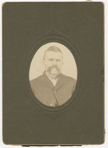 Photograph of a man with a mustache wearing a dark jacket, late 19th century. Creator: Unknown