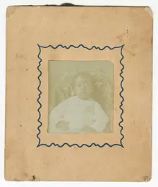 Photograph of a baby dressed in white and sitting in a chair, ca. 1870. Creator: Unknown