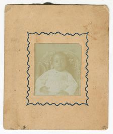 Photograph of a baby dressed in white and sitting in a chair, ca. 1870. Creator: Unknown