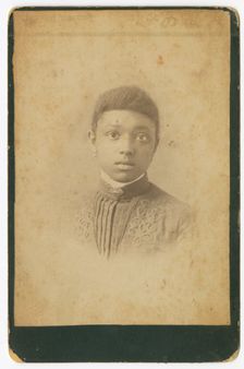 Photograph of a girl wearing a pleated dress, 1885-1900. Creator: Unknown