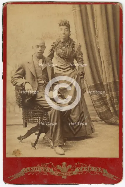 Photograph of African-American man and woman in formal clothes, late 19th century. Creator: Louis Janousek.