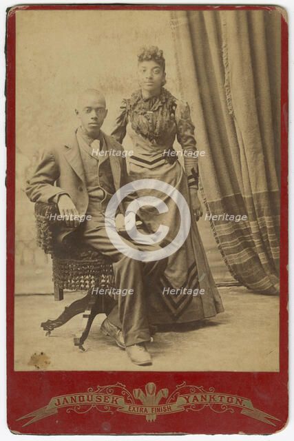 Photograph of African-American man and woman in formal clothes, late 19th century. Creator: Louis Janousek.