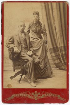 Photograph of African-American man and woman in formal clothes, late 19th century. Creator: Louis Janousek