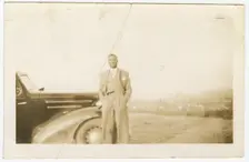 Photograph of an unidentified man in front of car, ca. 1920. Creator: Unknown