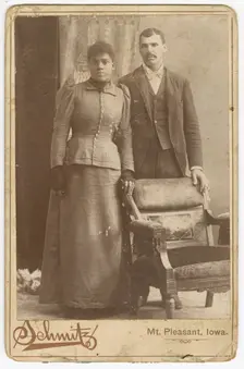 Photograph of an African-American couple standing behind a chair, ca. 1890. Creator: Schmitz Studio