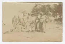 Photograph of men, women, and children in a yard, early 20th century. Creator: Unknown