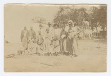 Photograph of men, women, and children in a yard, early 20th century. Creator: Unknown