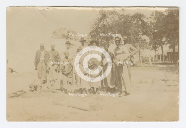 Photograph of men, women, and children in a yard, early 20th century. Creator: Unknown.