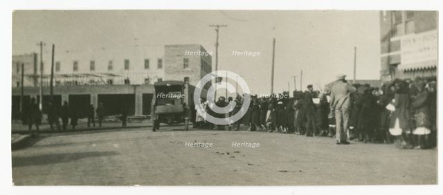 Photograph of people standing in a line on a street in Tulsa, Oklahoma, ca. 1920. Creator: Unknown.