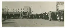 Photograph of people standing in a line on a street in Tulsa, Oklahoma, ca. 1920. Creator: Unknown
