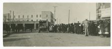 Photograph of people standing in a line on a street in Tulsa, Oklahoma, ca. 1920. Creator: Unknown