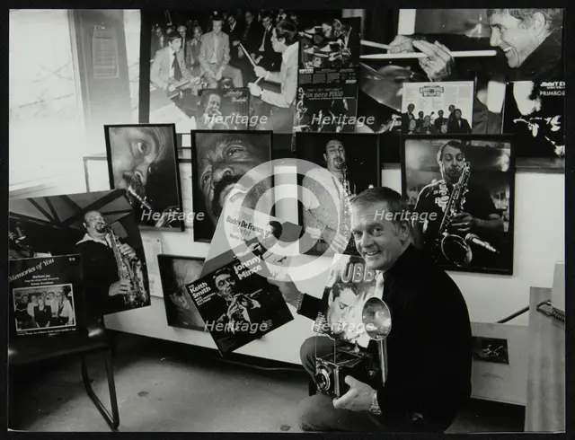Photographer Denis Williams holding an LP cover. Creator: Unknown.