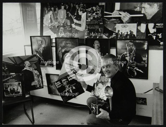 Photographer Denis Williams holding an LP cover. Creator: Unknown.