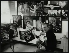 Photographer Denis Williams holding an LP cover. Creator: Unknown