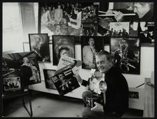 Photographer Denis Williams holding an LP cover. Creator: Unknown
