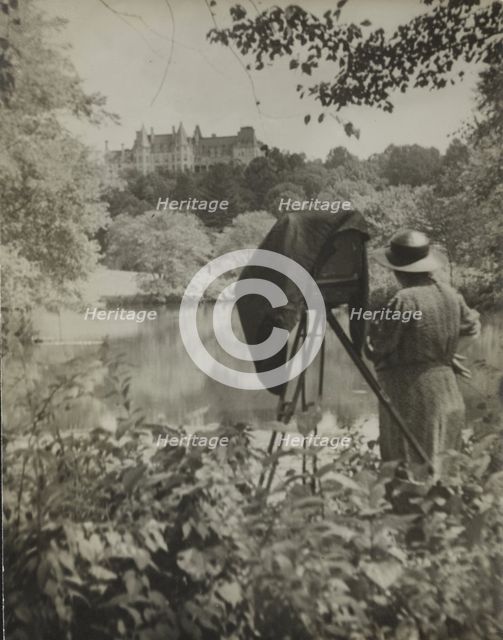 Photographer Frances Benjamin Johnston standing beside her large view camera looking..., c1938. Creator: Unknown.