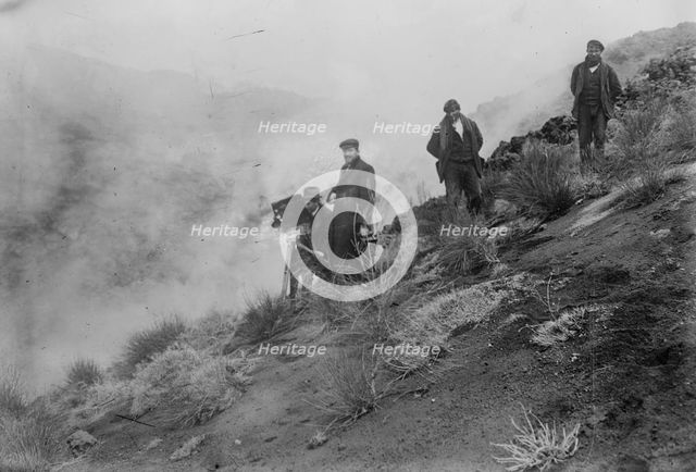 Photographers on hillside photographing Mt. Etna eruption, 1910. Creator: Bain News Service.