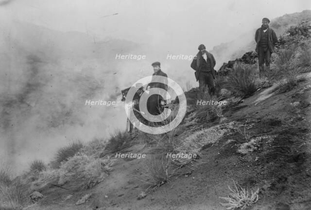 Photographers on hillside photographing Mt. Etna eruption, 1910. Creator: Bain News Service.