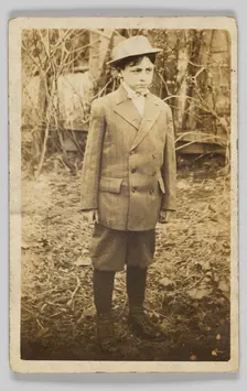 Photographic postcard of a boy wearing a double-breasted jacket and breeches, early 20th century. Creator: Unknown