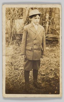 Photographic postcard of a boy wearing a double-breasted jacket and breeches, early 20th century. Creator: Unknown