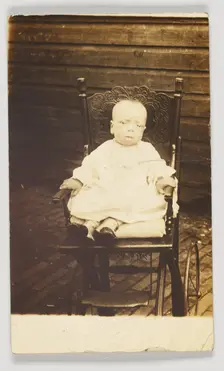 Photographic postcard of a baby in a stroller, 1918-1930. Creator: Unknown
