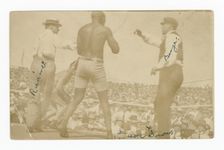 Photographic postcard of James J. Jeffries staggering away from Jack Johnson, 1910. Creator: Unknown