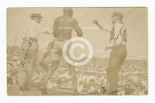 Photographic postcard of James J. Jeffries staggering away from Jack Johnson, 1910. Creator: Unknown.