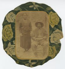 Photographic portrait of a man and woman on floral paper backing, early 20th century. Creator: Unknown