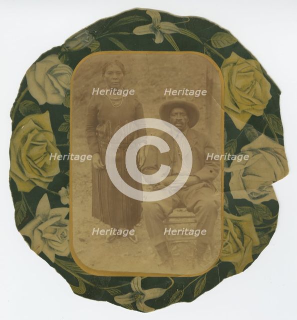 Photographic portrait of a man and woman on floral paper backing, early 20th century. Creator: Unknown.