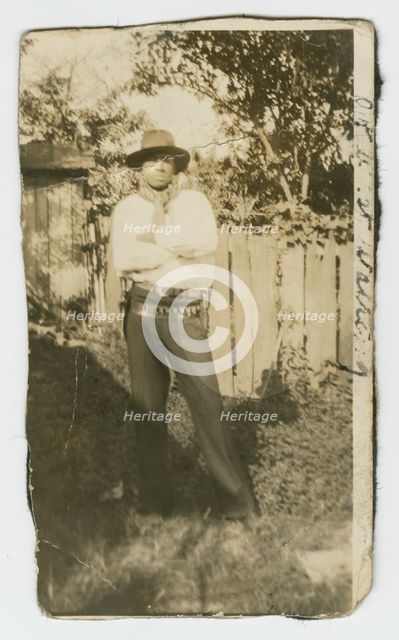 Photographic portrait of a man wearing hat and gun holster, early 20th century. Creator: Unknown.