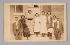 Photographic print of 8 people in front of a building, 1904-1918. Creator: Unknown