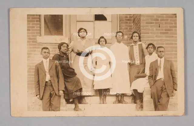 Photographic print of 8 people in front of a building, 1904-1918. Creator: Unknown.