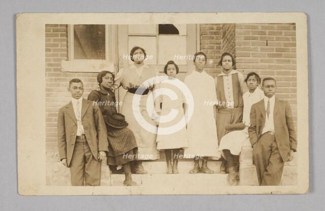 Photographic print of 8 people in front of a building, 1904-1918. Creator: Unknown.