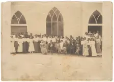 Photographic print of men and women in front of Vernon AME Church, Tulsa, ca. 1919. Creator: Unknown