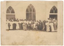 Photographic print of men and women in front of Vernon AME Church, Tulsa, ca. 1919. Creator: Unknown
